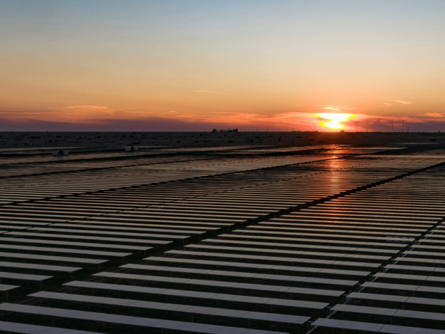 A large solar park at sunset.